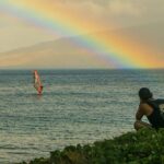 a rainbow over a body of water