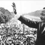 Martin Luther King, Jr. standing in front of a crowd