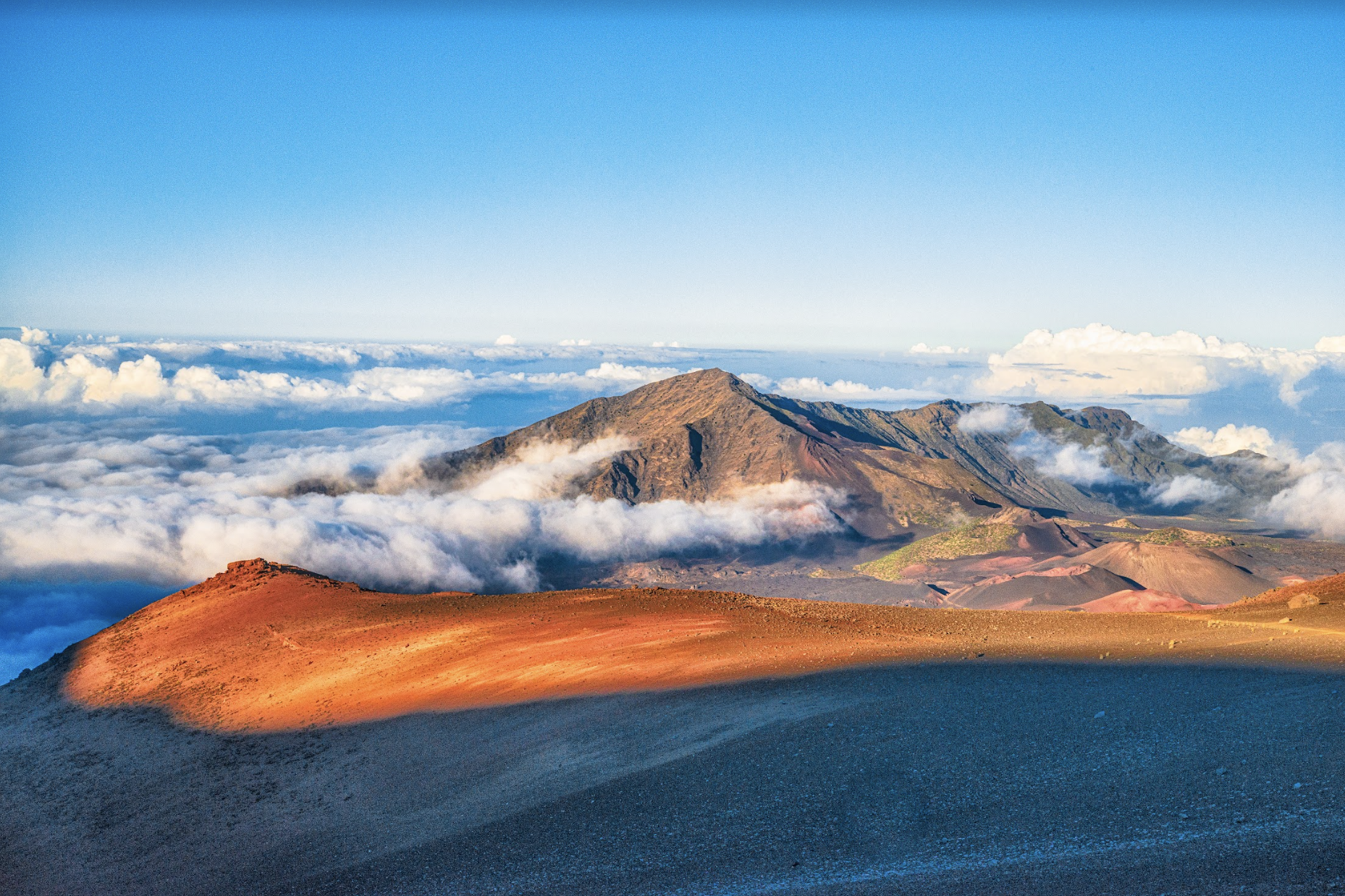 Peak of Haleakala Crater witih blue sky and white clouds in the sky